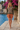 Walking waterfront editorial in terracotta shorts