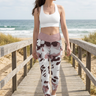 White sports bra and leggings on a beach boardwalk