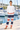 White sweatshirt and striped joggers at the marina