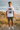 White tee with olive shorts without beanie