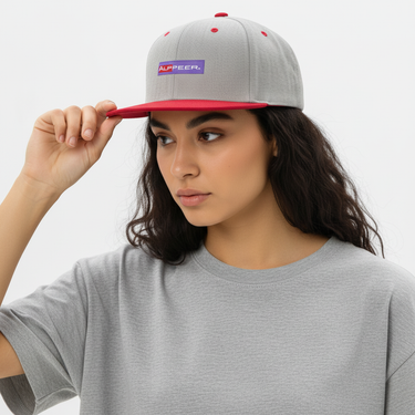 Woman wearing heather grey and red snapback, three-quarter view