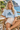 Your model in the light-blue crop top at a cliffside café